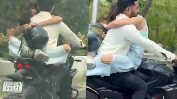 बीच सड़क पर खुल्लम खुल्ला रोमांस! गर्लफ्रेंड को गोद में बैठाकर दौड़ाई बाइक, अब थाने में इस हाल में दिखा बॉयफ्रेंड